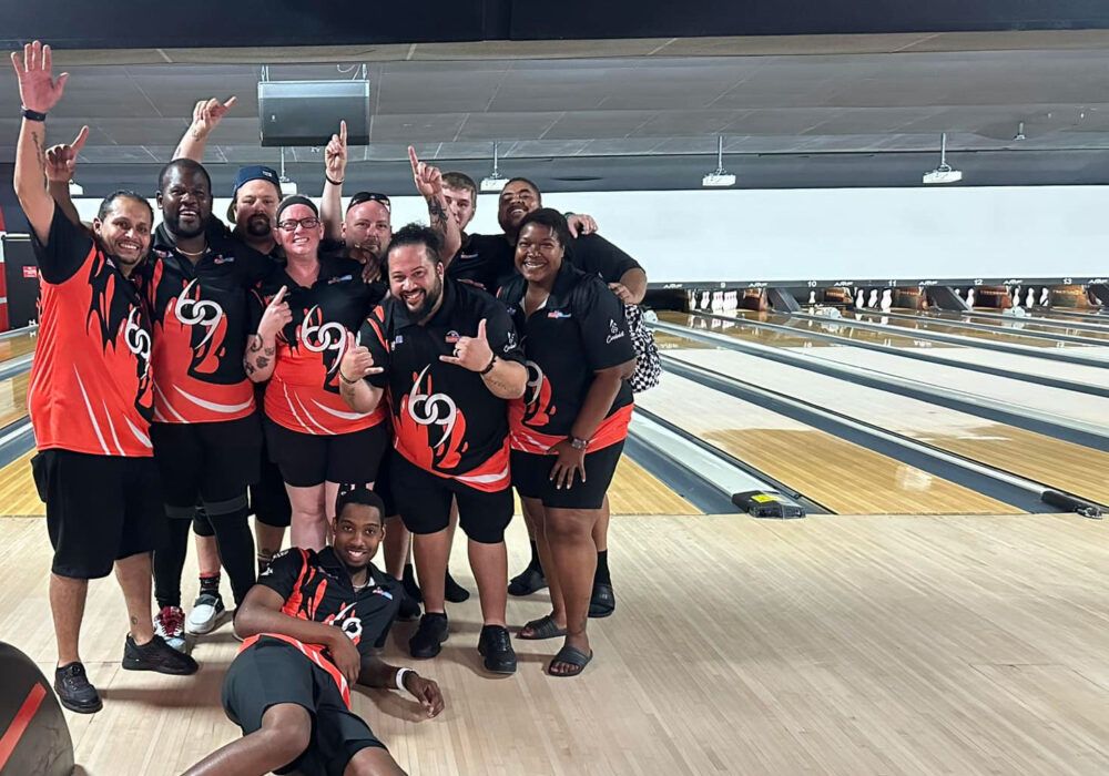 Bowling Federation members celebrating together at a tour stop